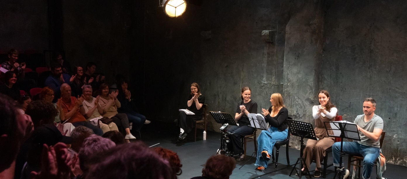 A play reading at The Mick Lally Theatre as part of Druid Debuts 2024 with a view of both the audience and the actors on the stage.