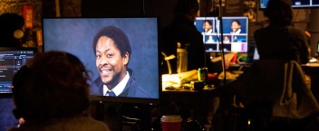 A behind the scenes photo of Druid's first live streamed production, Once Upon a Bridge by Sonya Kelly, featuring actor Adetomiwa Edun on a bank of screens in the foyer of The Mick Lally Theatre.