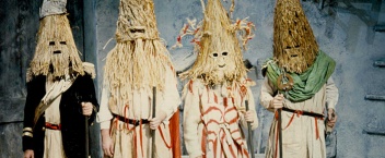 A production photo from At the Black Pig's Dyke by Vincent Woods (1992) featuring four actors dressed as mummers.