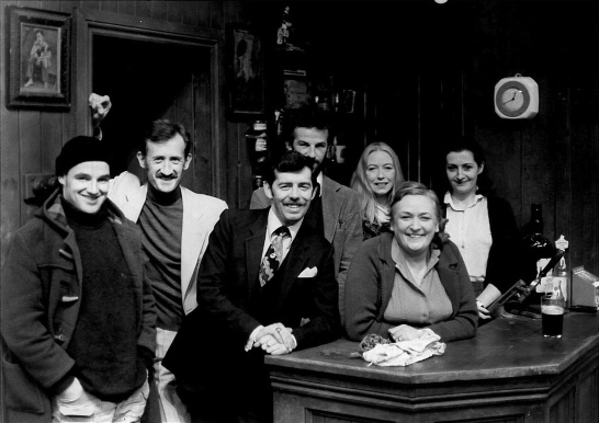 The cast of Tom Murphy's Conversations on a Homecoming in a black-and-white production photo.