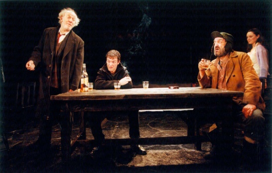 A production photo of Marina Carr's On Raftery's Hill featuring the cast gathered around a kitchen table.