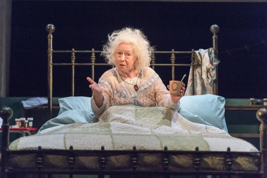 A production photo of Marie Mullen as Mommo in bed in Bailegangaire by Tom Murphy.