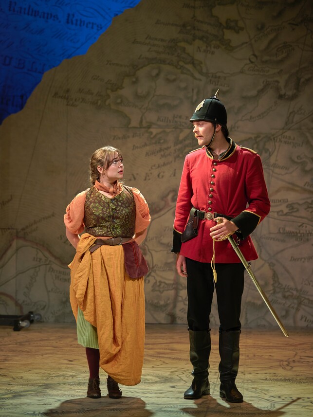 Megan Cusack as Claire Ffolliott and Fintan Kinsella as Captain Molineux looking in each others eyes