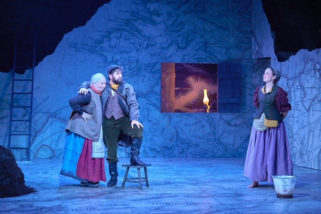 Aaron Monaghan as Conn 'The Shaughraun' hugs Marie Mullen as Mrs O'Kelly while Pattie Maguire as Moya looks on smiling