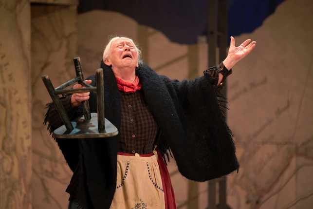 Marie Mullen as Mrs O'Kelly weeping while holding a stool in her hand
