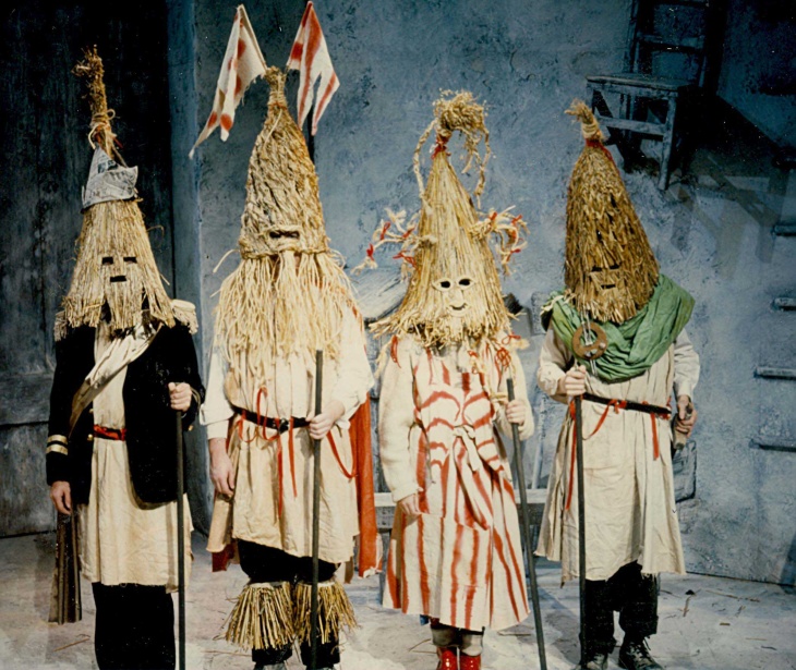 A production photo from At the Black Pig's Dyke by Vincent Woods (1992) featuring four actors dressed as mummers.