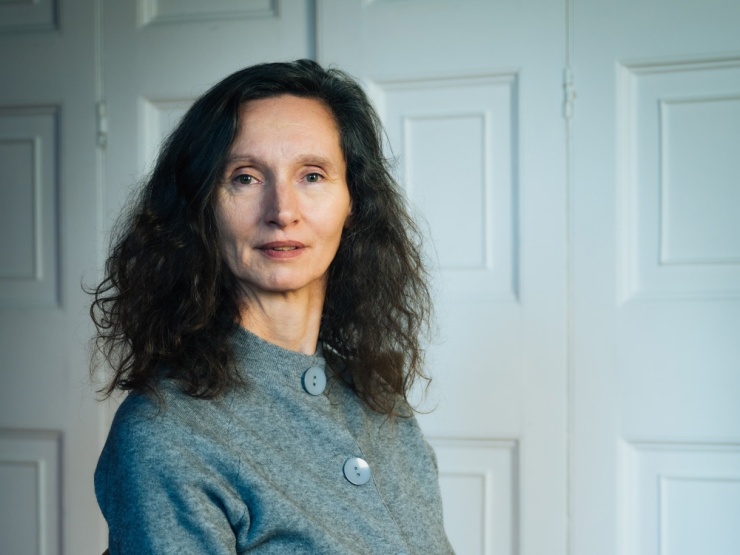 A colour photo of Maureen Kennelly in front of white doors.